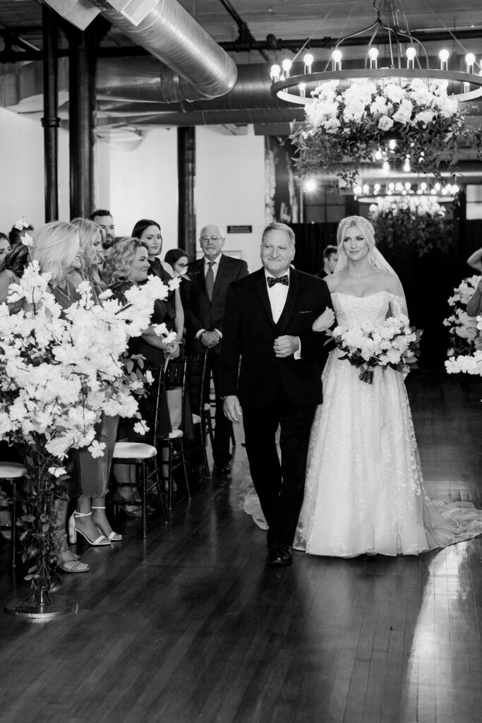 bride walking down the aisle with her dad